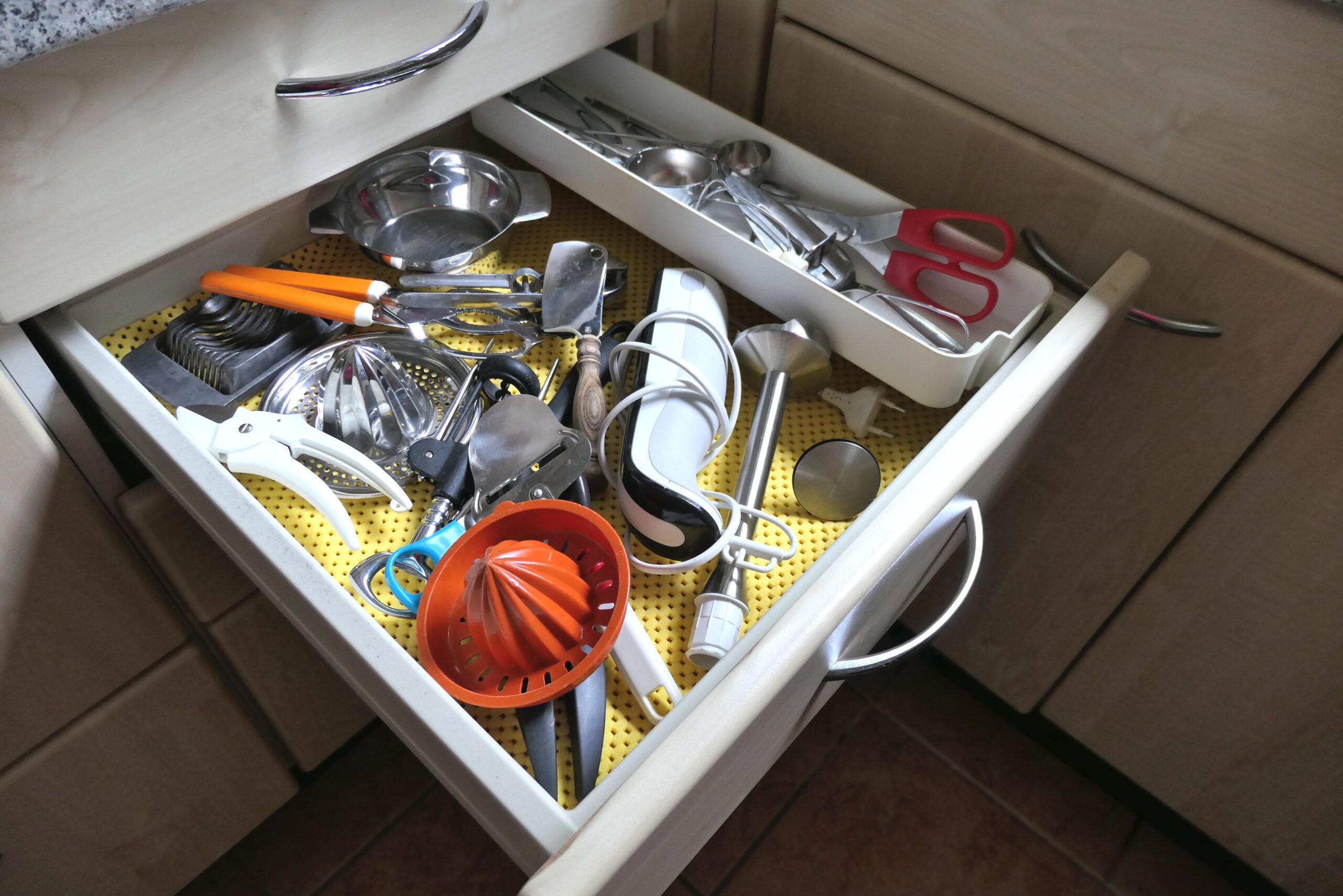 Kitchen utensils in an open drawer